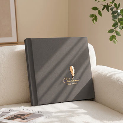 Vegan leather wedding photo album resting on a living room sofa