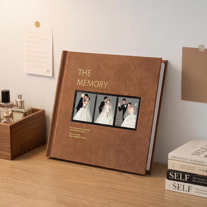 Custom wedding photo album with photo window cover displayed on a desk